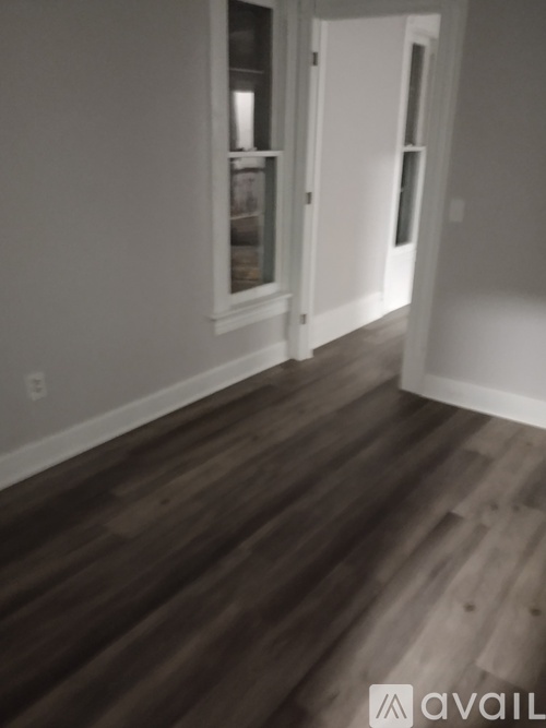 A room with wooden floors and white walls.