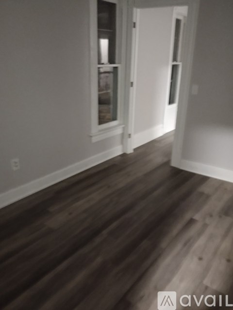 A room with wooden floors and white walls.
