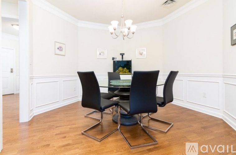 A dining room with a table and chairs.