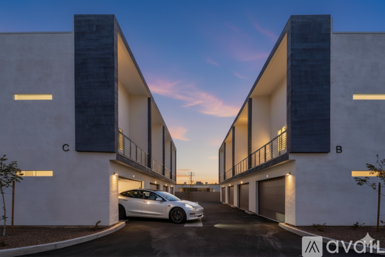 A modern two-story building with a car parked in front of it.
