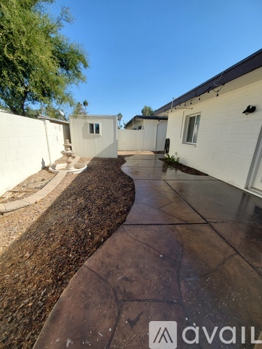 A white house with a brown walkway in front.