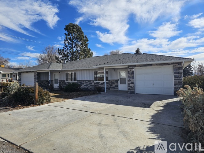 A house with a garage is for sale.