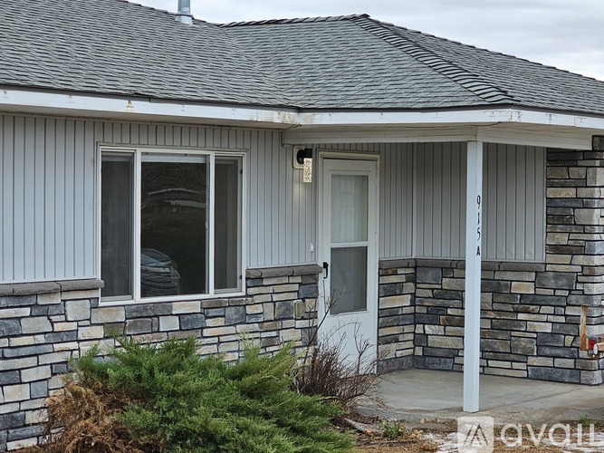 A house with a grey roof and a grey door.