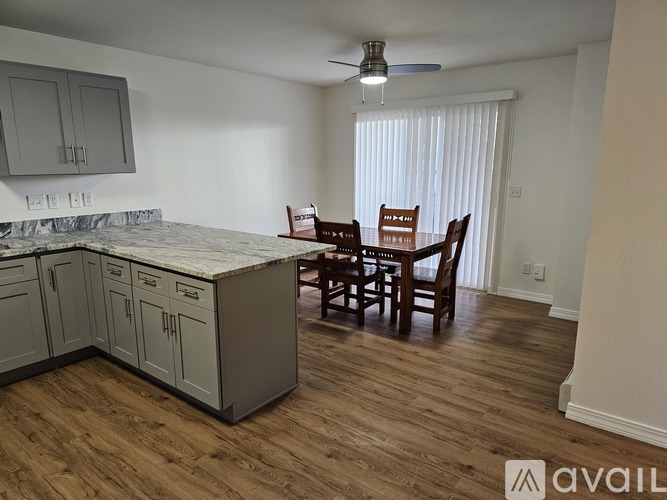 A kitchen with a dining table and chairs.