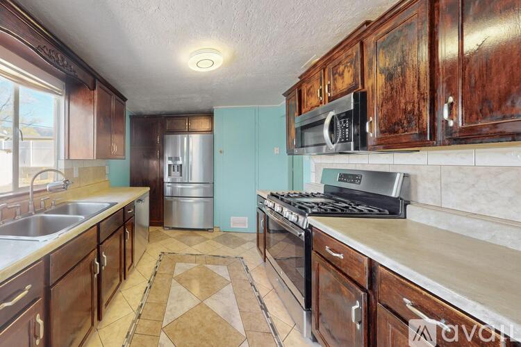 A kitchen with wooden cabinets and a stove top oven.