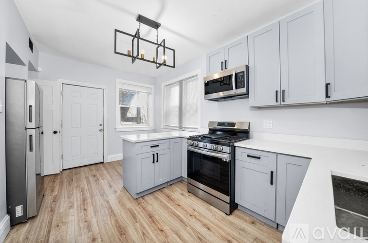 A kitchen with wooden floors and white walls.
