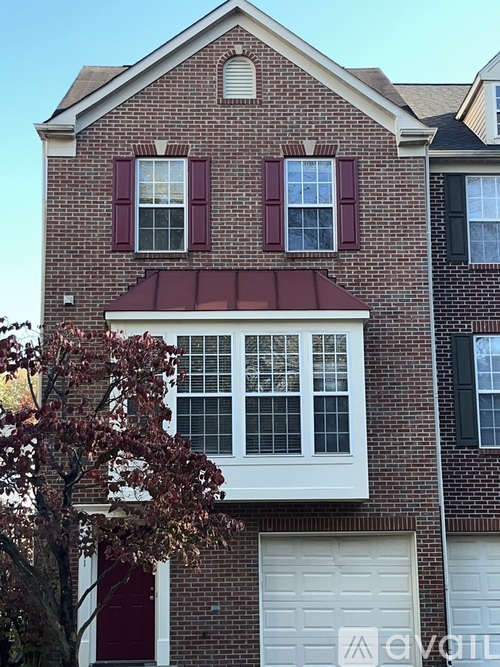 A red brick house with a white garage door.