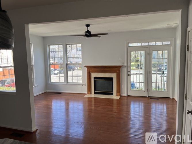 A living room with a fireplace and sliding glass doors.