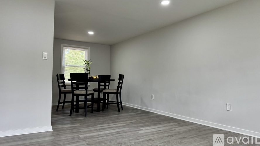 A dining room with a table and chairs.