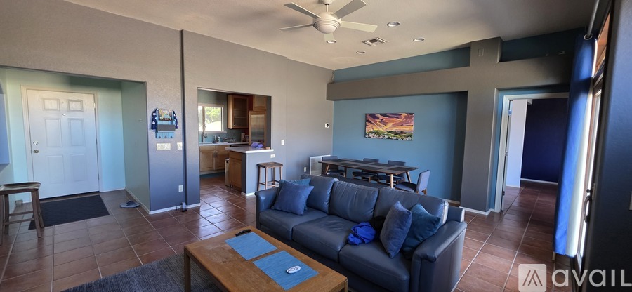 A living room with a grey couch and a coffee table.