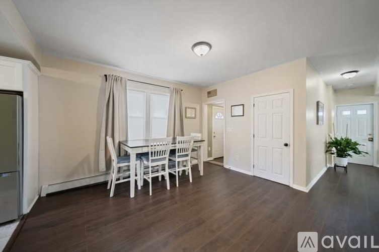 A dining room with a table and chairs.