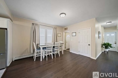 A dining room with a table and chairs.