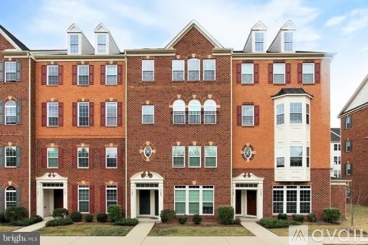A large red brick building with white trim and multiple windows.