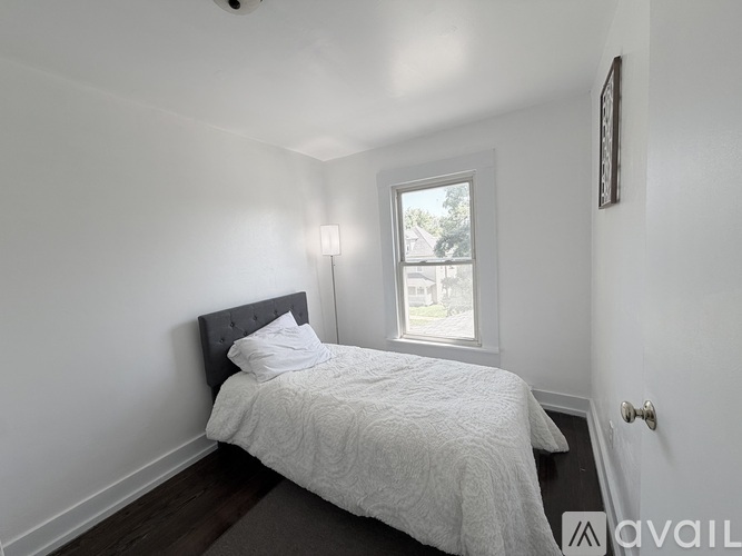 A white door with a white frame and a black floor.
