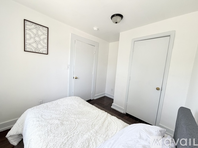 A room with a window and a door is available for rent.
