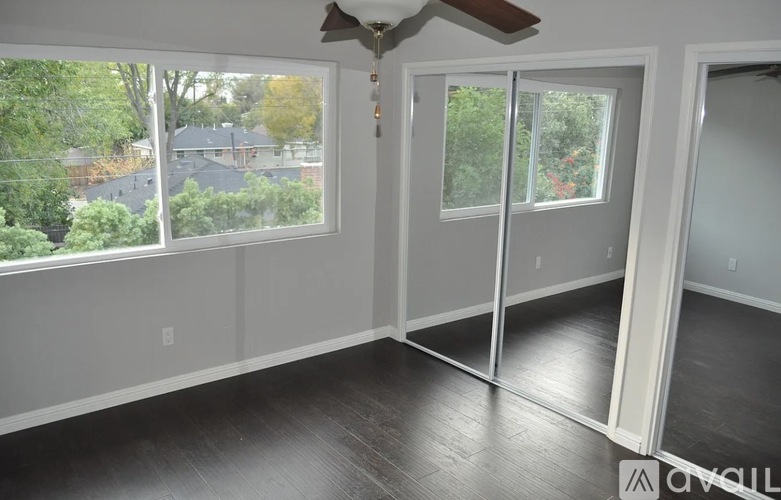 A room with a sliding glass door leading to a backyard.