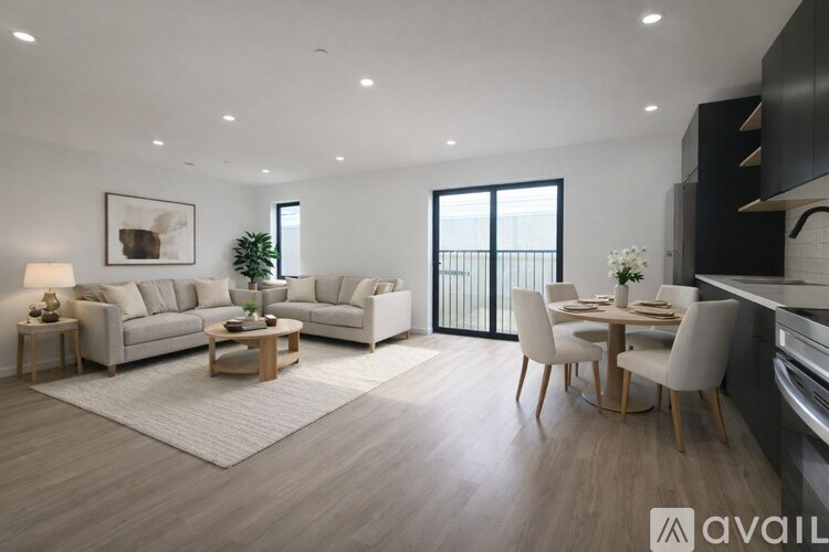 A modern living room with a dining area and a balcony.