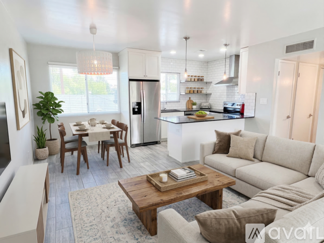 A modern kitchen with a dining table and chairs.