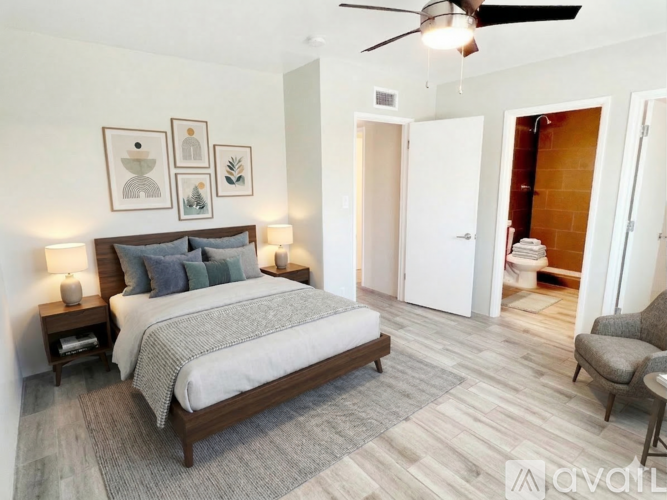 A bedroom with a large bed and a ceiling fan.
