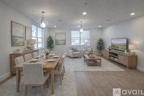 A well-lit, spacious dining room with a wooden table and chairs.