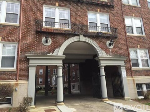 A red brick building with a white archway entrance.