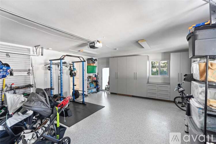 A spacious garage with a variety of equipment and a bicycle.