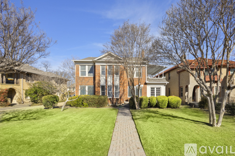A house with a brick pathway leading to the front door.