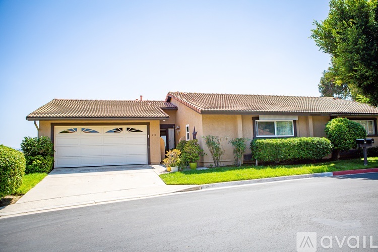 A house with a brown roof and a white garage door.