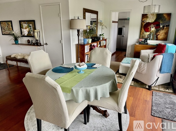 A dining room with a table set for four.