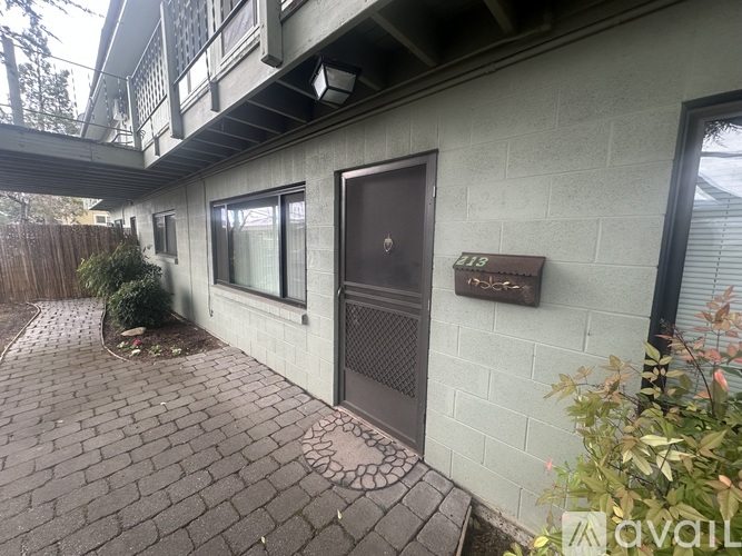 A house with a brown door and a mailbox on the wall.