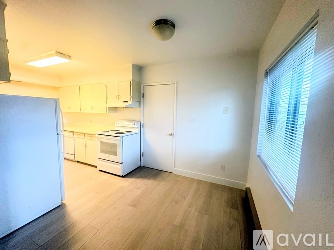 A kitchen area with a refrigerator, microwave, and oven.