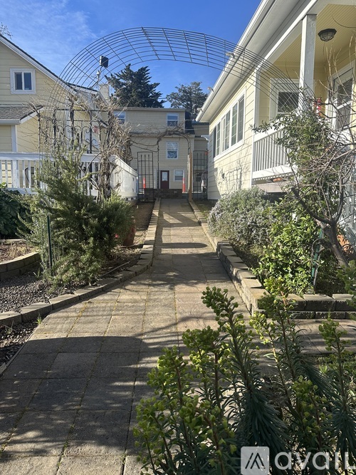 A sunny day in a courtyard surrounded by houses.