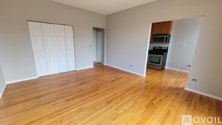 A room with wooden flooring and a white door.