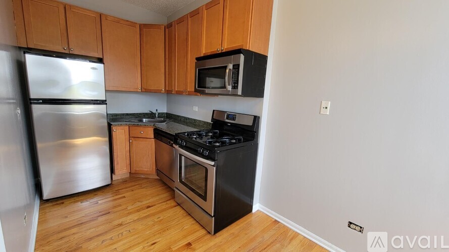 A kitchen with wooden cabinets and stainless steel appliances.