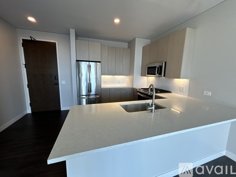 A kitchen with a sink and a refrigerator.