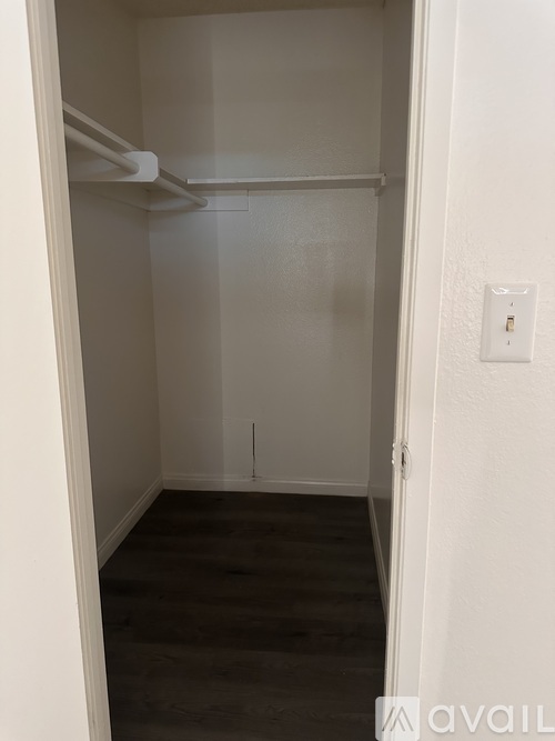 A small, empty room with a light switch on the wall.