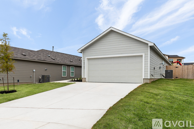 A house with a garage and a driveway in front.