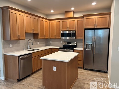 A kitchen with wooden cabinets and stainless steel appliances.