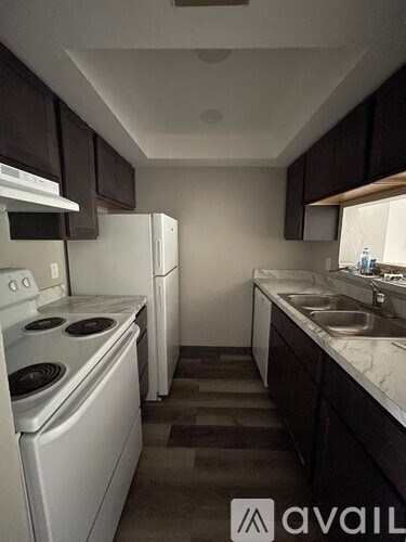 A room with a television and a white box on the floor.