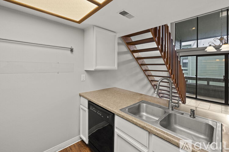 A kitchen with a stainless steel sink and a stainless steel dishwasher.