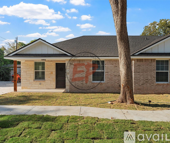 A house with a tree in front of it.
