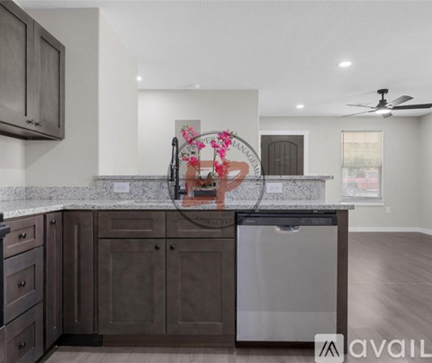 A modern kitchen with dark brown cabinets and a stainless steel dishwasher.