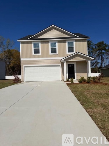 A two-story house with a garage is for sale.