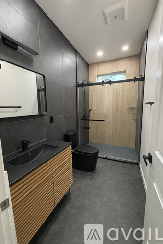 A bathroom with a sink, mirror, and toilet.