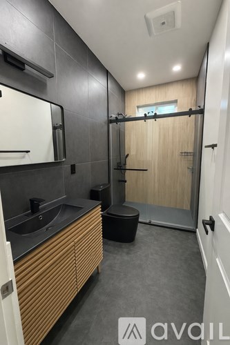 A bathroom with a sink, mirror, and toilet.
