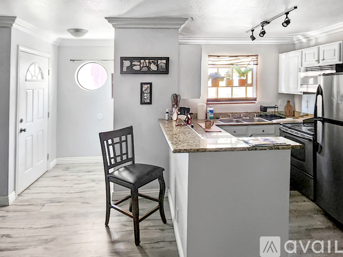 A kitchen with a chair and a counter.