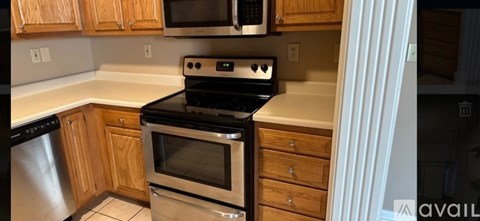 A kitchen with wooden cabinets and a black stove top oven.