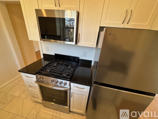 A kitchen with a stove top oven and a microwave above it.