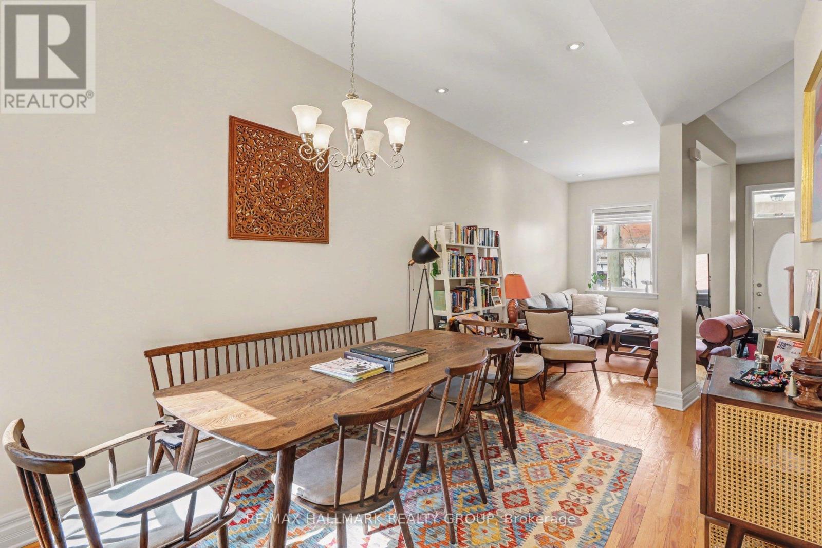 A dining room with a wooden table and chairs.