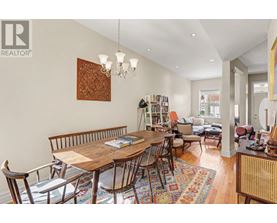 A dining room with a wooden table and chairs.